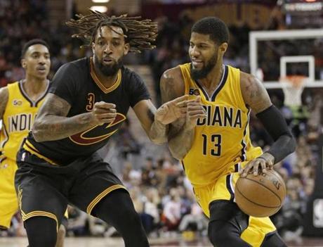 Indiana Pacers' Paul George (13) drives past Cleveland Cavaliers' Derrick Williams (3) in the second half of an NBA basketball game, Wednesday, Feb. 15, 2017, in Cleveland. (AP Photo/Tony Dejak)
