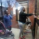 Boston, MA: 02-22-2017: Kyiesha Menzie arrives home at the Mildred C. Hailey Apartments, formerly known as Bromley-Heath, in the Jamaica Plain n neighborhood of Boston, Mass. Feb. 22, 2017. With her Is her daughter Summer Murrain (in carriage) and her son Jordan Cage (another son Joseph Murrain was there but can't be seenn). Photo/John Blanding, Boston Globe staff story/Evan Allen ( 23hailey )