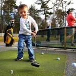 Milo Wilson, 3, from Kingston hit golf balls with his dad, Pete at Sandbaggers Driving Range in Pembroke on Saturday. 