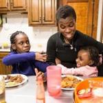 02/16/2017 ROSLINDALE, MA Sandy Guerrier (cq) (center) plays with her children Imanie (cq) (left) and Ammattieia (cq) during dinner at their home in Roslindale. (Aram Boghosian for The Boston Globe) 