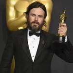 Casey Affleck poses in the press room with the award for best actor in a leading role for 
