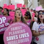 FILE - In this Sept. 9, 2015, file photo, Planned Parenthood supporters rally for women's access to reproductive health care on 