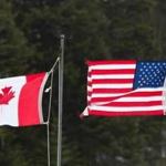 Canadian and American flags are seen at the US/Canada border March 1, 2017, in Pittsburg, New Hampshire. / AFP PHOTO / Don EMMERTDON EMMERT/AFP/Getty Images