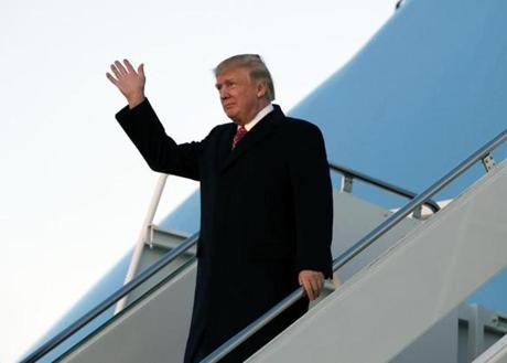 President Trump waved Sunday upon arriving back at Andrews Air Force Base, Md.
