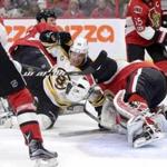 As the Senators defense closed in, the Bruins' David Pastrnak crashed into Ottawa goaltender Craig Anderson.