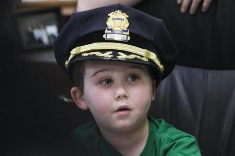 Devin Suau wore a police hat after being sworn in as honorary chief. 
