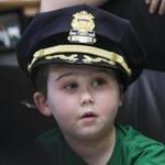Devin Suau wore a police hat after being sworn in as honorary chief. 
