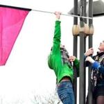 Two women placed a pink flag on a lightpost during a demonstration in France for International Women?s Day. 