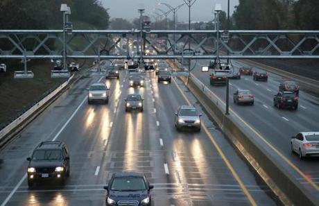 Traffic flowed under the new electronic tolling gantries on the Mass. Pike in October. 
