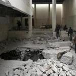 Iraqi federal police inspect a room in Mosul?s heavily damaged museum. Most of the artifacts were destroyed.