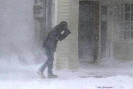 A pedestrian battled a snowy wind in Plymouth during a February storm. 
