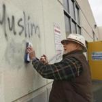 In February, Tom Garing cleans up racist graffiti painted on the side of a mosque in Roseville, Calif.