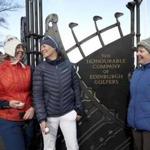 Holidaymakers Anna Dietrich, Pascale Reinhard and Jeanette Siehenthiler, from left, smile after playing a round of golf following the announcement that women will be admitted as members of Muirfield Golf Club after a membership ballot was held by The Honourable Company of Edinburgh Golfers, in Gullane, Scotland Tuesday, March 14, 2017. Muirfield Golf Club voted Tuesday to admit female members for the first time in its 273-year history, paving the way for the Scottish golf club to again host the British Open. ( Jane Barlow/PA via AP)