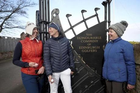 Holidaymakers Anna Dietrich, Pascale Reinhard and Jeanette Siehenthiler, from left, smile after playing a round of golf following the announcement that women will be admitted as members of Muirfield Golf Club after a membership ballot was held by The Honourable Company of Edinburgh Golfers, in Gullane, Scotland Tuesday, March 14, 2017. Muirfield Golf Club voted Tuesday to admit female members for the first time in its 273-year history, paving the way for the Scottish golf club to again host the British Open. ( Jane Barlow/PA via AP)
