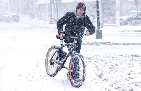 SNOW SLIDER2 Cambridge, MA - 3/14/2017 - Frank Odette pushes his bike through the snow near Kendall Square in Cambridge, MA, March 14, 2017. (Keith Bedford/Globe Staff)
