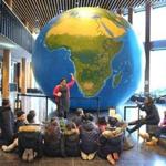 A huge, 20-foot inflatable globe was on display at Boston Public School headquarters in Dudley Square on Thursday, part of an effort to show students what the world really looks like.