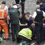 Foreign Office minister Tobias Ellwood (center) performed mouth-to-mouth resuscitation on the police officer who was stabbed and later died.