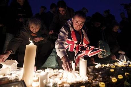 LONDON, ENGLAND - MARCH 23: Members of the public light candles during a candlelit vigil at Trafalgar Square on March 23, 2017 in London, England. Four People were killed in Westminster, London, yesterday in a terrorist attack by 