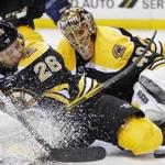 Boston Bruins' John-Michael Liles (26) moves to blocks the puck in front of teammate Tuukka Rask (40), of Finland, during the third period of an NHL hockey game against the Nashville Predators in Boston, Tuesday, March 28, 2017. The Bruins won 4-1. (AP Photo/Michael Dwyer)