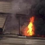 A large fire caused an overpass on Interstate 85 to collapse burns in Atlanta on Thursday.