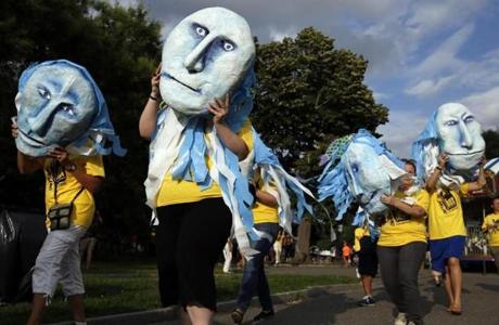 Volunteers donning masks made by the Boston Puppeteers cooperative celebrated the start of the Outside the Box Festival in Boston in 2015.
