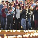 Candles lined a Falmouth High School athletic field as friends and classmates attended a vigil in December for James Lavin and Owen Higgins.