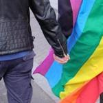 A couple held hands Wednesday as protesters marched through Amsterdam to show solidarity for two gay men who were badly beaten over the weekend in the eastern city of Arnhem. 
