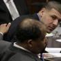Former New England Patriots tight end Aaron Hernandez, top right, looks toward defense attorney Ronald Sullivan, front, during his double murder trial at Suffolk Superior Court, Thursday, April 6, 2017, in Boston. Hernandez is on trial for the July 2012 killings of Daniel de Abreu and Safiro Furtado who he encountered in a Boston nightclub. The former NFL player is already serving a life sentence in the 2013 killing of semi-professional football player Odin Lloyd. (AP Photo/Steven Senne, Pool)