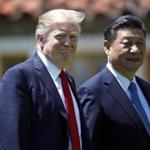 President Donald Trump and Chinese President Xi Jinping walk together at Mar-a-Largo on Friday. 