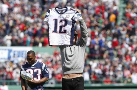 Boston, Massachusetts -- 4/3/2017 - New England Patriots quarterback Tom Brady holds up his jersey before the start of Red Sox Pirates during Opening Day at Fenway Park. (Jessica Rinaldi/Globe Staff) Topic: Reporter:
