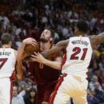 Cleveland Cavaliers forward Kevin Love (0) attempts a shot against Miami Heat center Hassan Whiteside (21) and guard Goran Dragic (7) during the first half of an NBA basketball game, Monday, April 10, 2017, in Miami. (AP Photo/Wilfredo Lee)