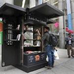 Jeffrey Alcantara of Roxbury checked out the offerings at a pop-up Little Free Library on Washington St.