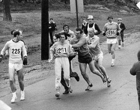 In 1967, Kathrine Switzer, of Syracuse, N.Y., center, was spotted early in the Boston Marathon by Jock Semple, center right, who tried to rip the number off her shirt and remove her from the race. 
