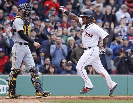 Boston Red Sox's Hanley Ramirez, right, pumps his fist as he passes Pittsburgh Pirates catcher Chris Stewart, left, while scoring on an RBI single by Xander Bogaerts during the eighth inning of a baseball game in Boston, Thursday, April 13, 2017. The Red Sox defeated the Pirates 4-3. (AP Photo/Charles Krupa)
