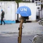This Feb. 22, 2017 photo shows a U.N. peacekeeper's blue helmet balanced on a weapon in Port-au-Prince, Haiti. 