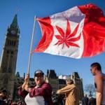 A woman waved a flag with a marijuana leaf on it next to a group gathered to celebrate National Marijuana Day last year on Parliament Hill in Ottawa, Canada.
