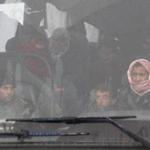 Syrians onboard a bus coming from government-held Fuaa and Kafraya arrive in rebel-held Rashidin, west of Aleppo city, as part of an evacuation deal, on April 14, 2017. Civilians and fighters began in the morning evacuating four towns besieged by rebels and government forces under a deal brokered by opposition backer Qatar and regime ally Iran, an AFP correspondent and local source told AFP. / AFP PHOTO / Omar haj kadourOMAR HAJ KADOUR/AFP/Getty Images