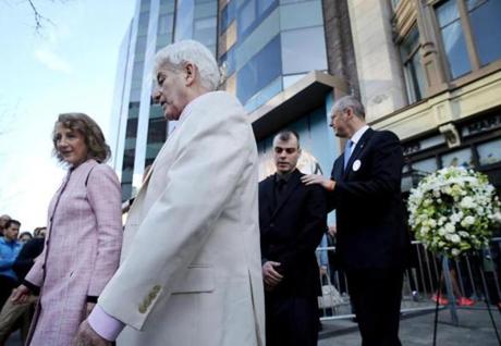 Boston, MA- April 15, 2017: (LEFT to RIGHT) First Lady Lauren Baker walks with William Campbell Jr, the father of Marathon bombing victim Krystle Campbell, while his son William Campbell III is joined by Governor Charles 