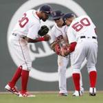 Boston, Massachusetts -- 4/16/2017 - (L-R) Red Sox players Chris Young, Andrew Benintendi and Mookie Betts celebrate their win over Tampa Bay at the end of the ninth inning of play at Fenway Park. (Jessica Rinaldi/Globe Staff) Topic: Red Sox-Rays Reporter: 