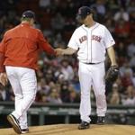 Boston Red Sox starting pitcher Steven Wright hands the ball to manager John Farrell as Wright is pulled from the baseball game against the Baltimore Orioles during the second inning Wednesday, April 12, 2017, in Boston. (AP Photo/Elise Amendola)