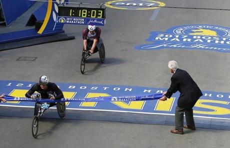 Wheelchair racer Marcel E. Hug (left) crossed the finish line.
