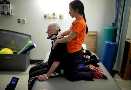 For Chris Hoeh, paralyzed in a skiing accident, physical therapy is a regular part of life. Therapist Mellissa Agriman-akis treated him at a recent Spaulding Hospital session.
