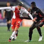 New England Revolution's Lee Nguyen, left, takes the ball upfield as D.C. United's Kofi Opare tries to slow him down in the first half at Gillette Stadium in Foxboro, Mass., Saturday, April 22, 2017. Gretchen Ertl for The Boston Globe.