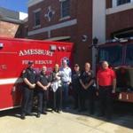 23zoblotter - Left to right: Firefighter-EMT Ryan York, Firefighter-Paramedic James Bateman, Hillary Sheridan, baby Henry Sheridan, Kevin Sheridan, Firefighter-EMT Jamie Clark, Firefighter-EMT Brian Dixon and Firefighter-Paramedic Carl Rizzo. (Amesbury Fire Rescue)