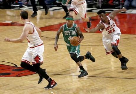 Boston Celtics' Isaiah Thomas (4) leads the fast break past Chicago Bulls' Jimmy Butler (21) and toward Paul Zipser during the second half in Game 4 of an NBA basketball first-round playoff series in Chicago, Sunday, April 23, 2017. (AP Photo/Charles Rex Arbogast)

