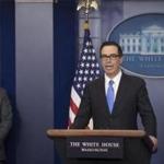 Treasury Secretary Steven Mnuchin speaks with reporters at a press briefing at the White House where he announced new U.S. sanctions in response to the Syrian chemical weapons attack, April 24, 2017. The Trump administration on Monday said it was sanctioning 271 employees of the Syrian government agency that produces chemical weapons and ballistic missiles, blacklisting them from travel and financial transactions in the wake of a sarin attack on civilians this month. White House Press Secretary Sean Spicer is at left. (Stephen Crowley/The New York Times)