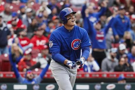 Chicago Cubs' Anthony Rizzo watches his three-run home run off Cincinnati Reds starting pitcher Cody Reed in the first inning of a baseball game, Saturday, April 22, 2017, in Cincinnati. (AP Photo/John Minchillo)
