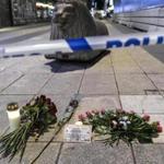 Candles and flowers are placed near the site where a beer truck crashed into a department store in central Stockholm, Sweden, Friday, April 7, 2017. The hijacked beer truck plowed into pedestrians at the central Stockholm department store on Friday, sending screaming shoppers fleeing in panic in what Sweden's prime minister called a terrorist attack. (Maja Suslin/TT NEWS AGENCY via AP)