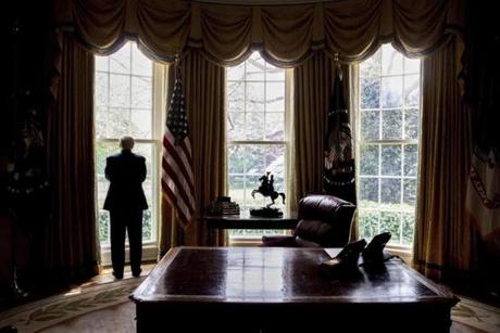 In this photo taken April 21, 2017, President Donald Trump looks out an Oval Office window at the White House in Washington following an interview with The Associated Press. Health care is complicated. China can be a useful ally. NATO is not obsolete. Being president is hard. Over the course of his 100 days in office, President Donald Trump has been startlingly candid about his public education in the ways of Washington and the world. (AP Photo/Andrew Harnik)
