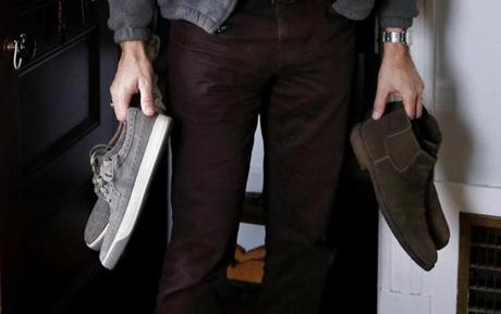 Arlington, Massachusetts -- 4/13/2017 - Jay Sparks holds two of his new pairs of shoes as he poses for a photo at his home in Arlington.Sparks, a suburban father of four, said he's not a high-style kind of guy, but in recent years, his shoe collection has expanded. (Jessica Rinaldi/Globe Staff) Topic: 21shoes Reporter: 
